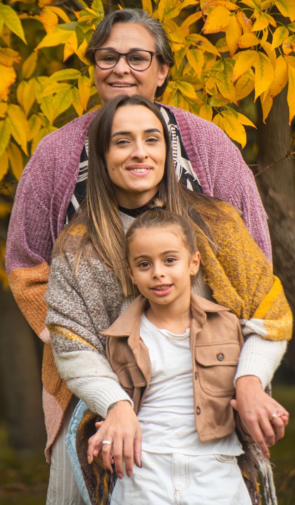 Three generations of women smiling in a park during fall in Montevideo, Uruguay.